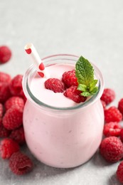 Yummy raspberry smoothie in jar and fresh berries on table Image of Yummy raspberry smoothie in jar and fresh berries on table