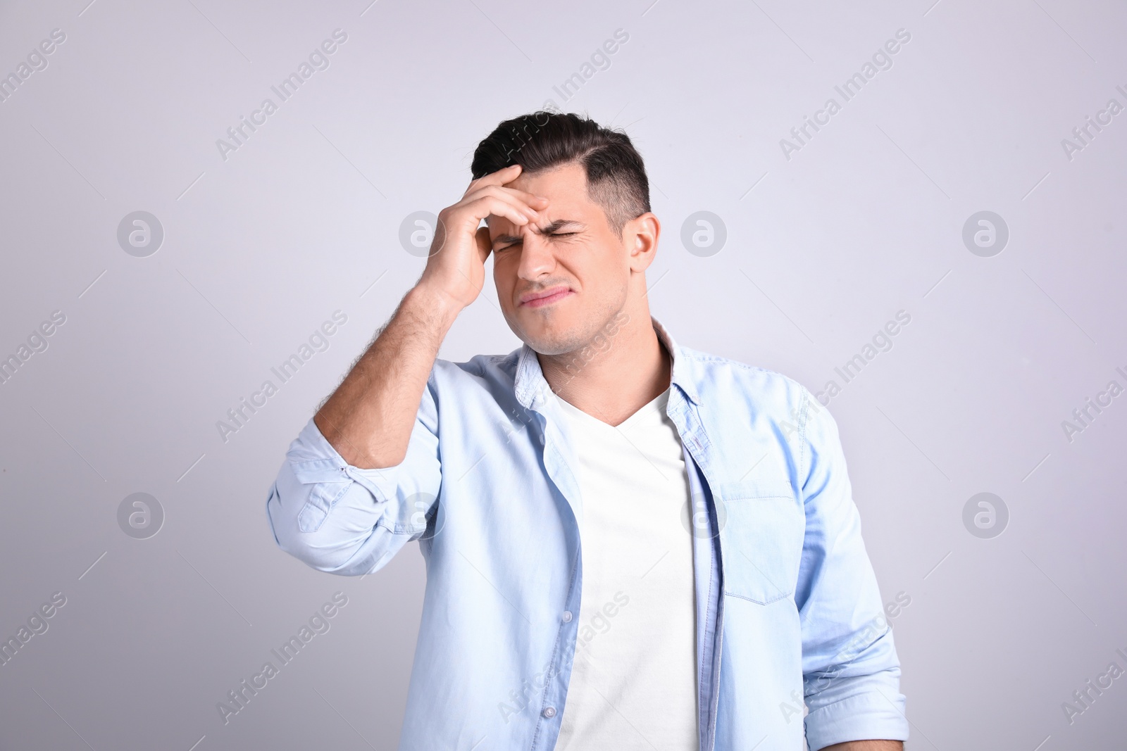 Portrait of stressed man on light background Photo of Portrait of stressed man on light background