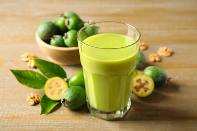 Fresh feijoa smoothie and fresh fruits on wooden table, closeup Photo of Fresh feijoa smoothie and fresh fruits on wooden table, closeup