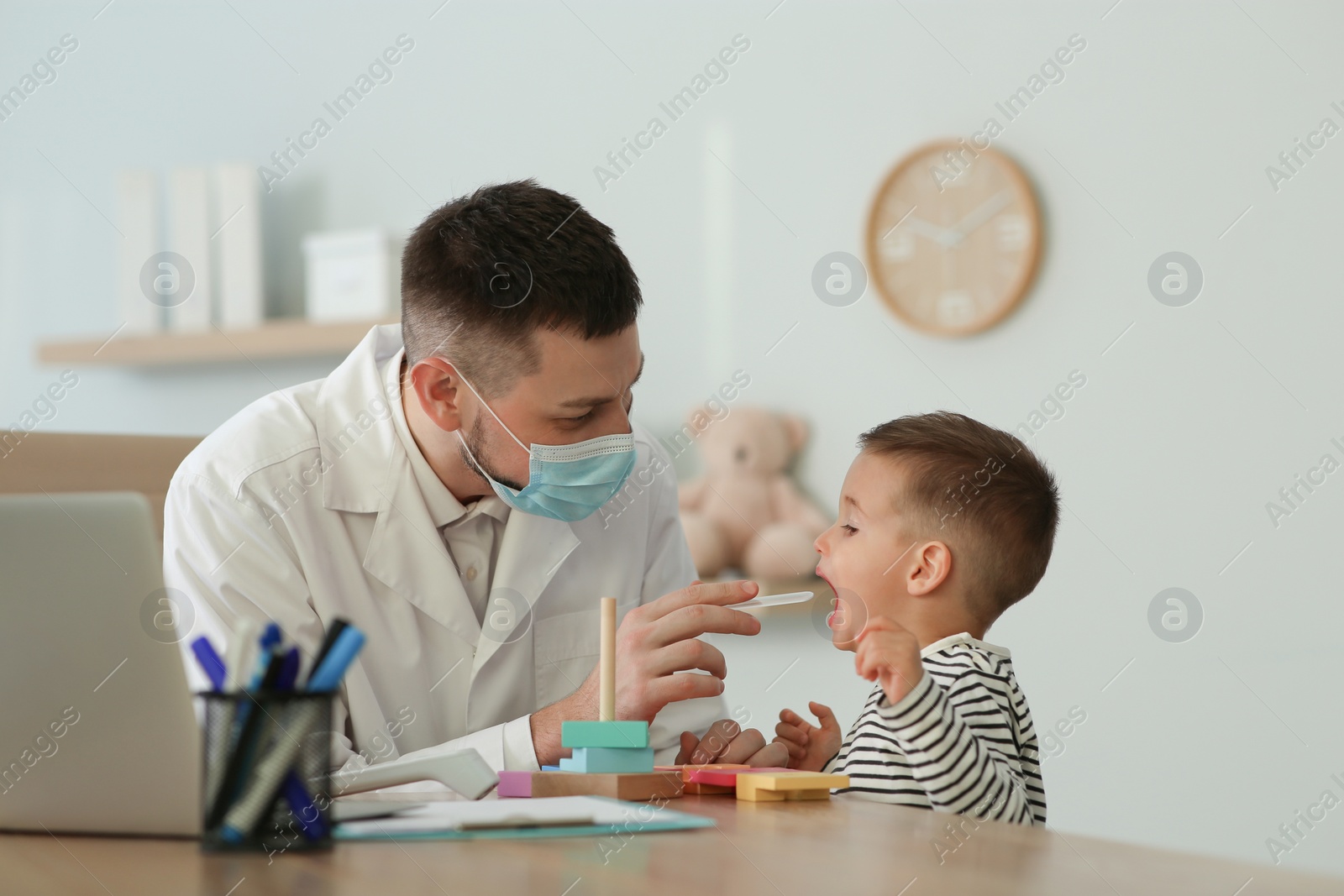 Pediatrician examining cute little boy at hospital Photo of Pediatrician examining cute little boy at hospital