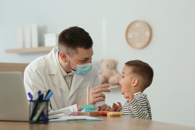 Pediatrician examining cute little boy at hospital Photo of Pediatrician examining cute little boy at hospital