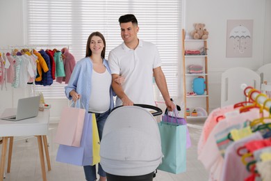 Happy pregnant woman with her husband choosing baby stroller in store. Shopping concept Photo of Happy pregnant woman with her husband choosing baby stroller in store. Shopping concept