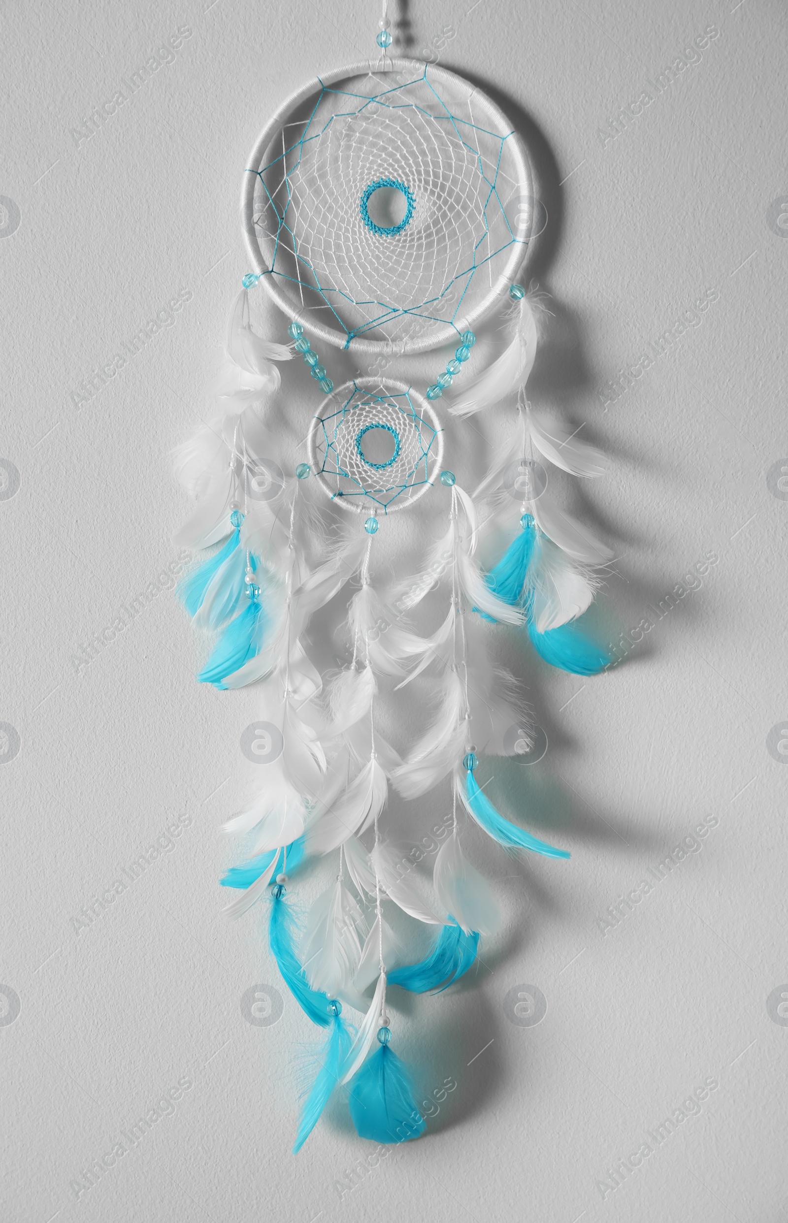 Photo of Beautiful dream catcher hanging on white wall