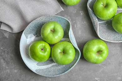 Composition with fresh green apples on grey table, top view Photo of Composition with fresh green apples on grey table, top view