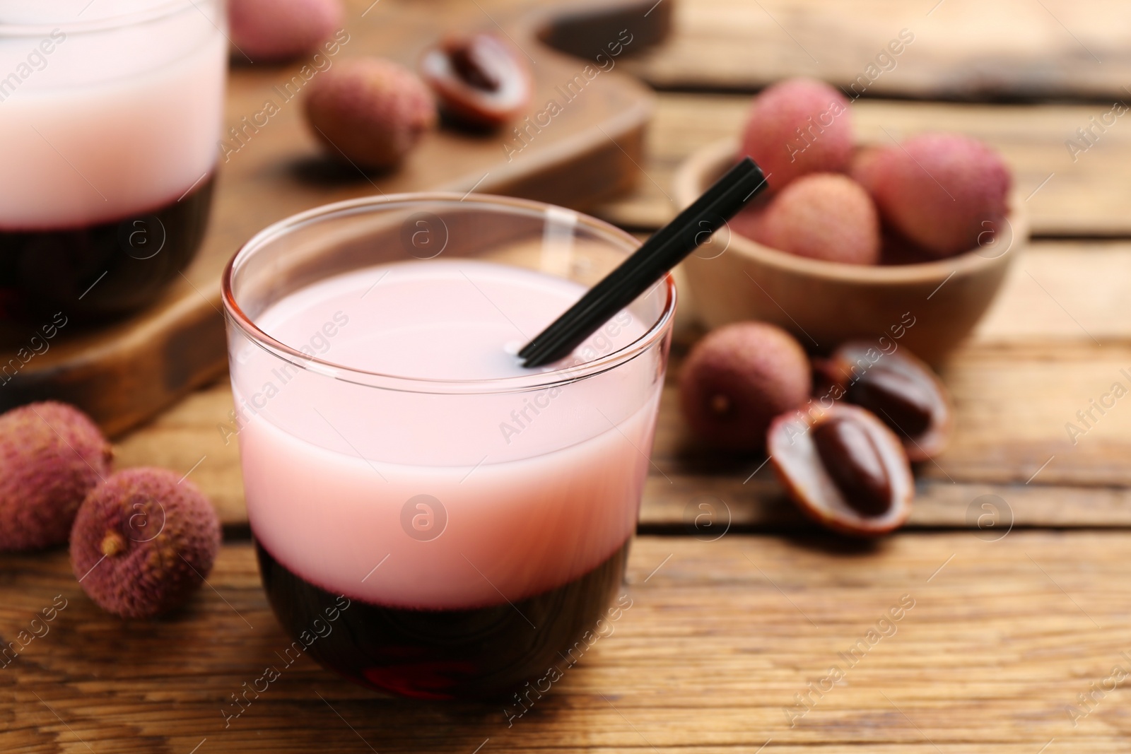 Tasty lychee cocktail on wooden table, closeup Photo of Tasty lychee cocktail on wooden table, closeup