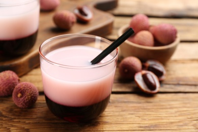Tasty lychee cocktail on wooden table, closeup Photo of Tasty lychee cocktail on wooden table, closeup