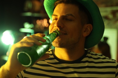 Man with beer celebrating St Patrick's day in pub, closeup Photo of Man with beer celebrating St Patrick's day in pub, closeup