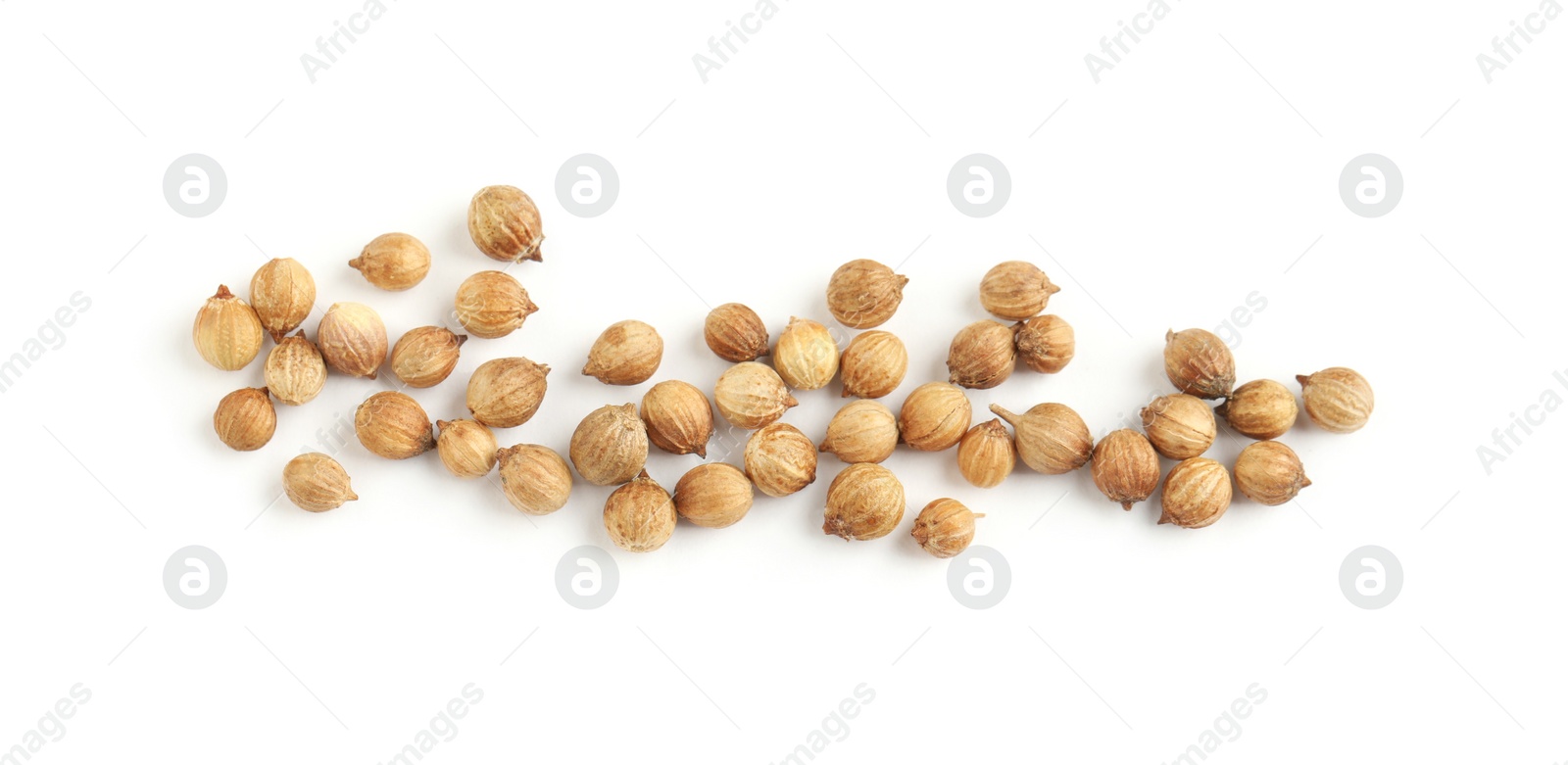 Photo of Scattered dried coriander seeds on white background, top view