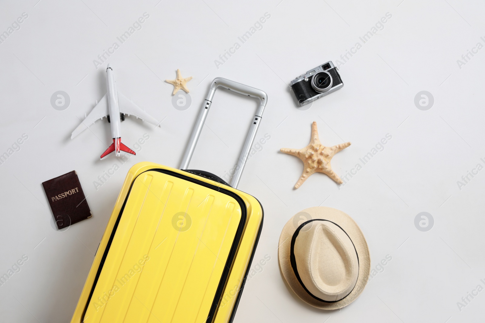 Photo of Flat lay composition with suitcase and travel accessories on grey background. Summer vacation