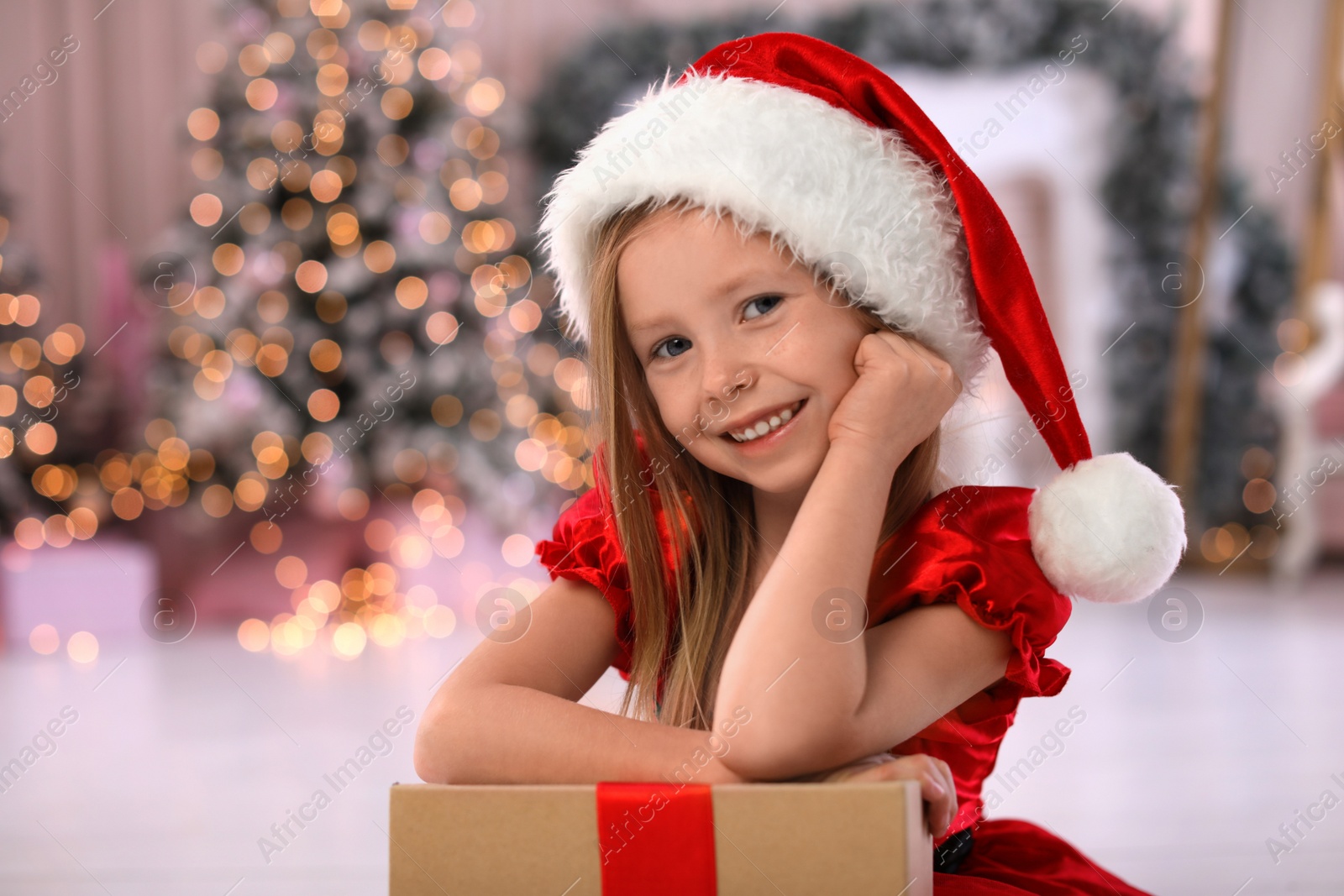 Cute little child with Christmas gift at home Photo of Cute little child with Christmas gift at home