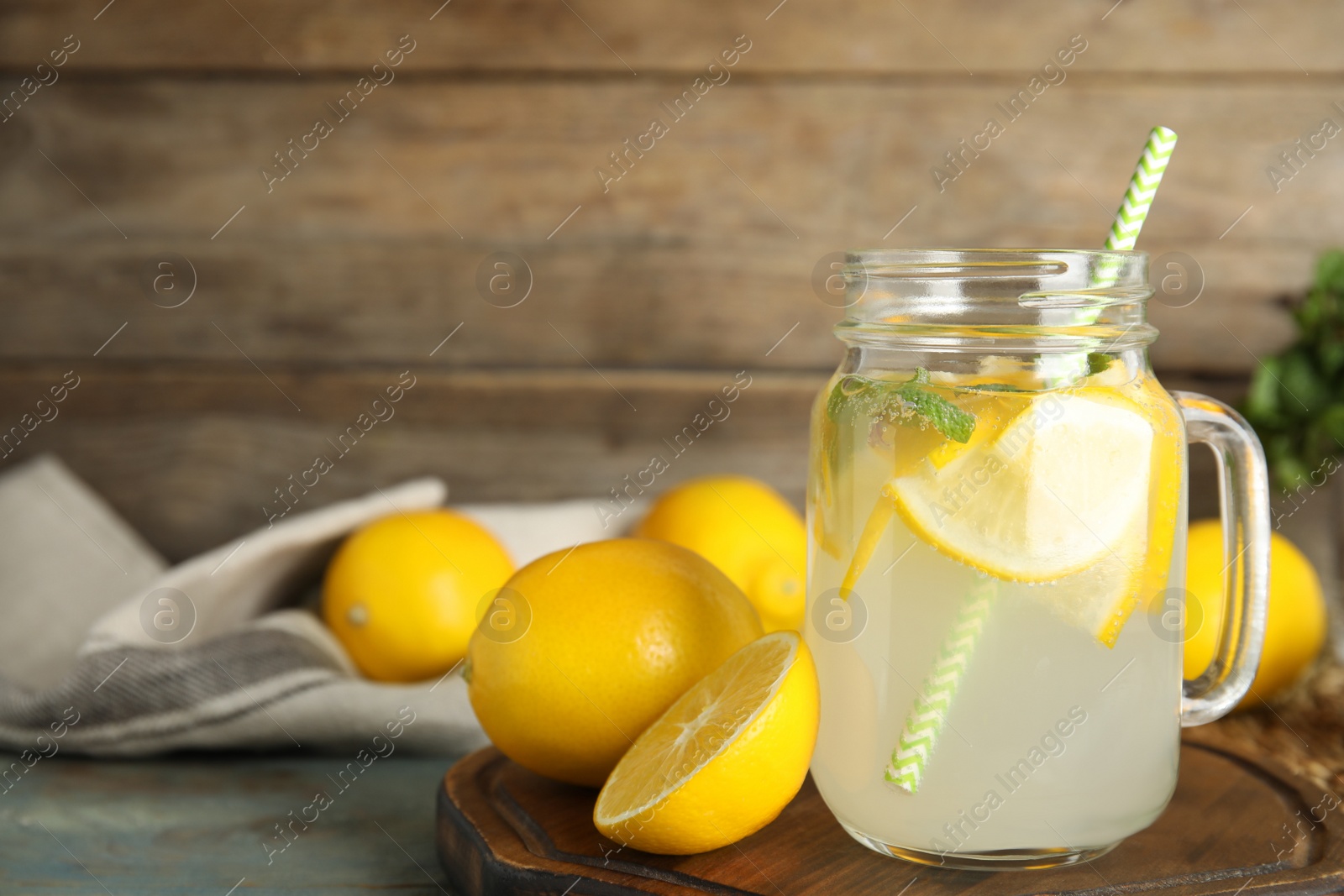 Cool freshly made lemonade and fruits on wooden table. Space for text Photo of Cool freshly made lemonade and fruits on wooden table. Space for text