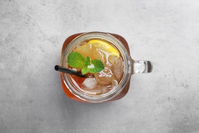 Delicious iced tea with lemon and mint on grey table, top view Photo of Delicious iced tea with lemon and mint on grey table, top view