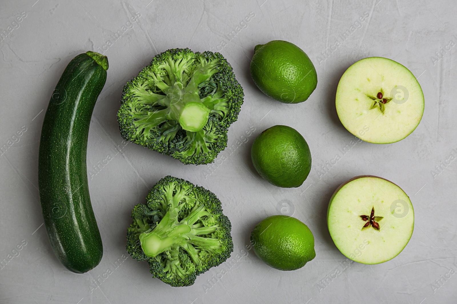 Different green vegetables and fruits on grey background, top view Photo of Different green vegetables and fruits on grey background, top view