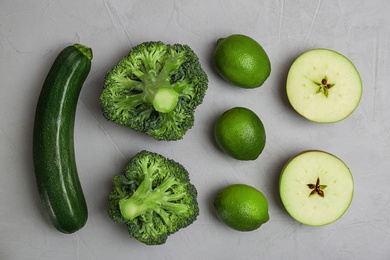 Different green vegetables and fruits on grey background, top view Photo of Different green vegetables and fruits on grey background, top view