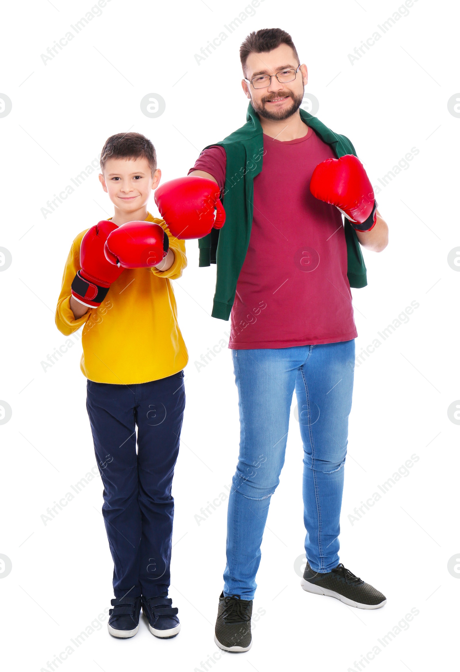 Little boy and his dad in boxing gloves on white background Photo of Little boy and his dad in boxing gloves on white background