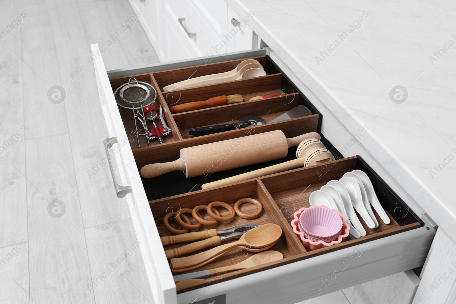 Open drawer with utensil set indoors. Order in kitchen Photo of Open drawer with utensil set indoors. Order in kitchen