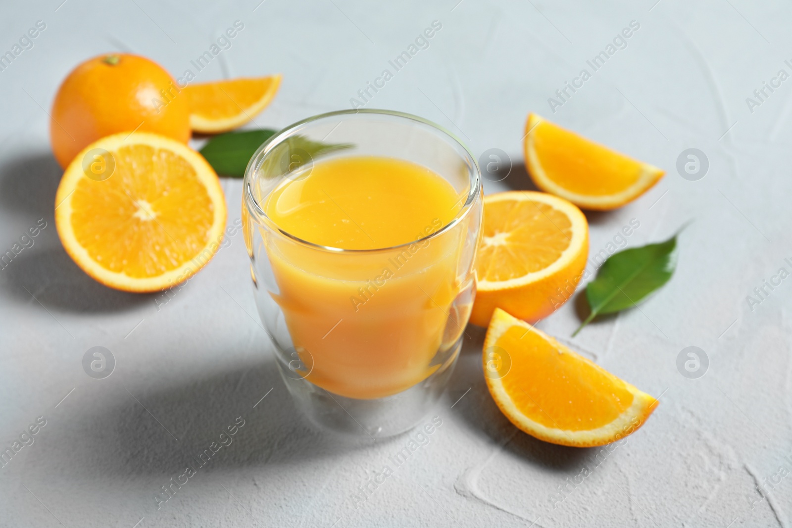 Glass of orange juice and fresh fruits on table Photo of Glass of orange juice and fresh fruits on table