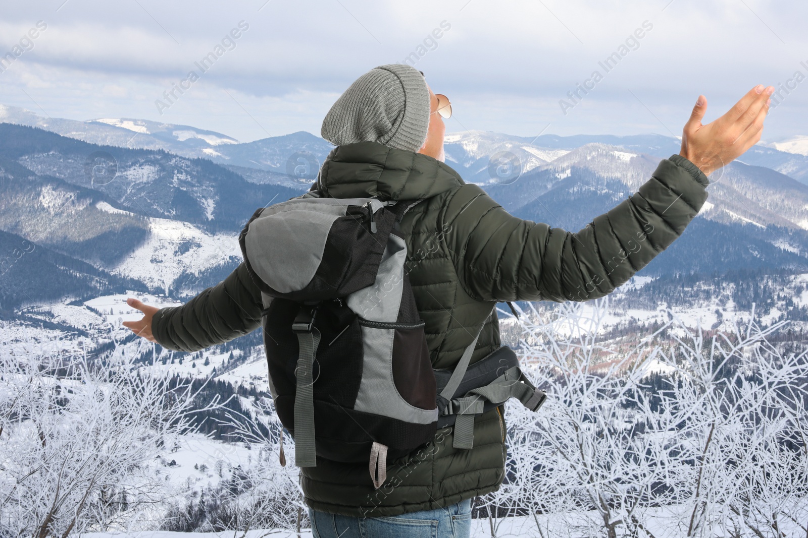 Tourist with travel backpack enjoying mountain landscape during vacation trip Image of Tourist with travel backpack enjoying mountain landscape during vacation trip