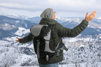 Tourist with travel backpack enjoying mountain landscape during vacation trip Image of Tourist with travel backpack enjoying mountain landscape during vacation trip