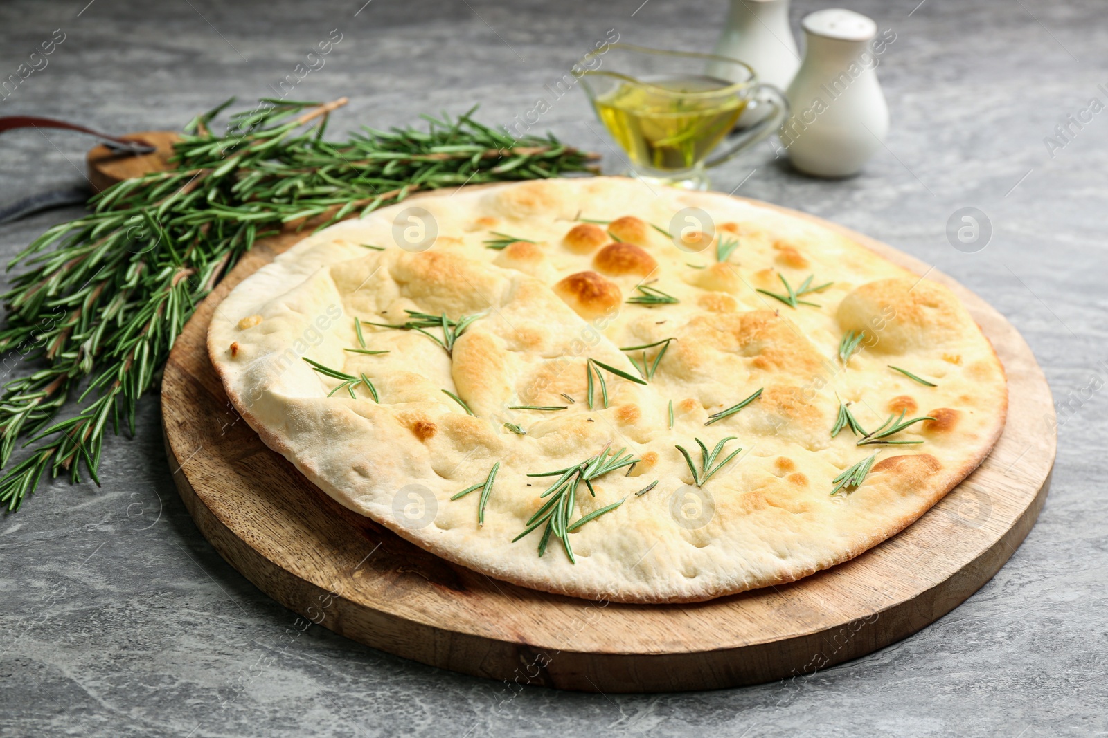 Delicious fresh focaccia bread on grey table Photo of Delicious fresh focaccia bread on grey table