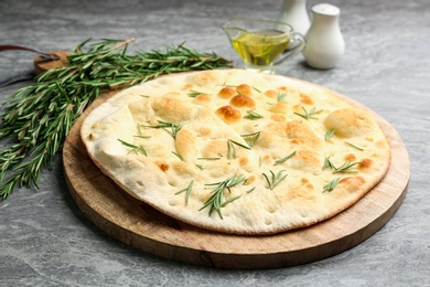 Delicious fresh focaccia bread on grey table Photo of Delicious fresh focaccia bread on grey table