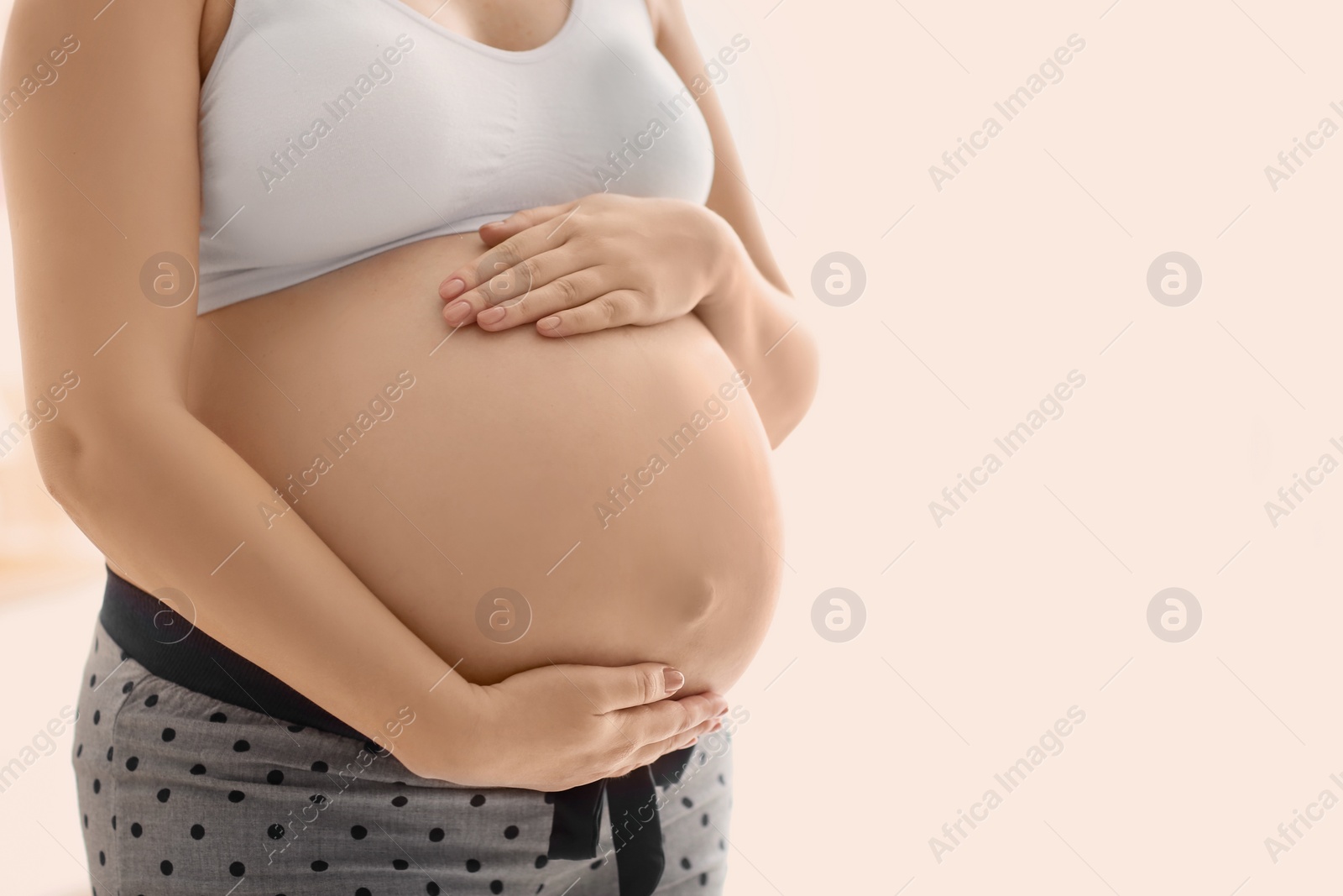 Pregnant woman after application of body cream on blurred background, closeup Photo of Pregnant woman after application of body cream on blurred background, closeup