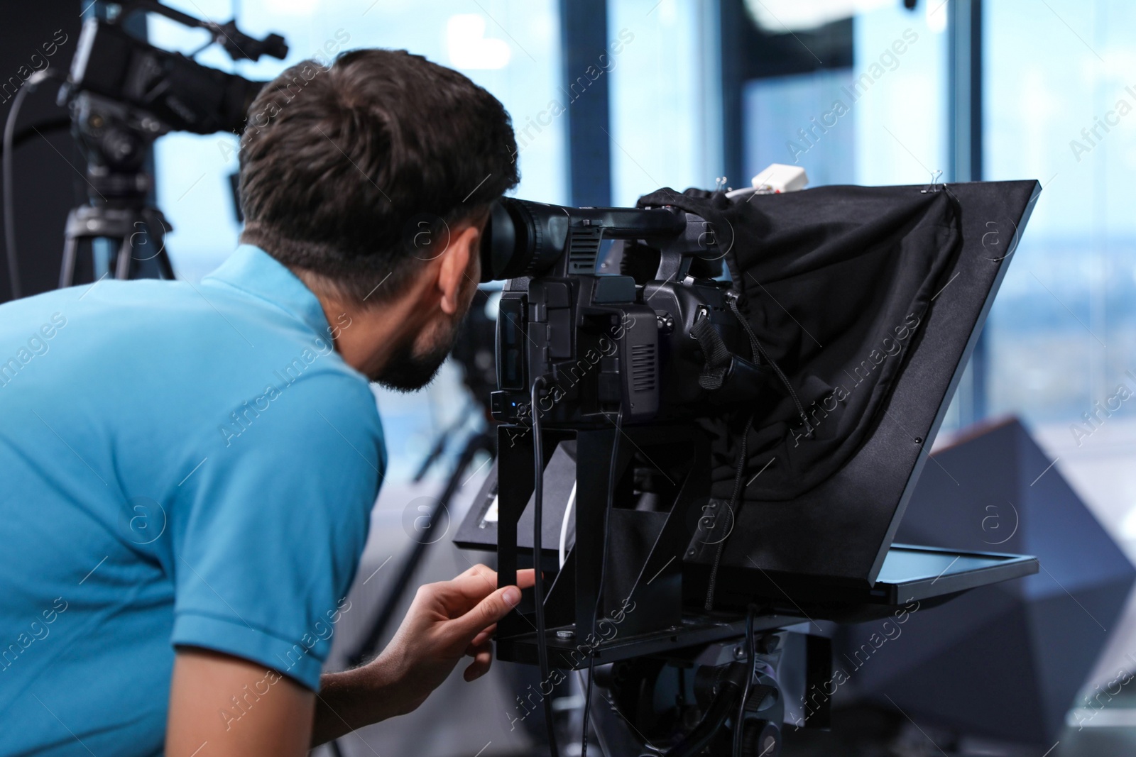 Professional video camera operator working in studio Photo of Professional video camera operator working in studio