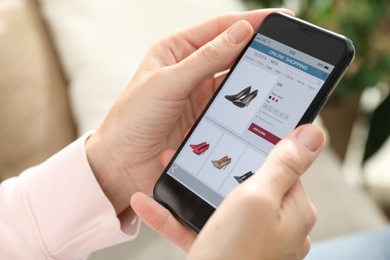 Woman using smartphone for online shopping indoors, closeup Photo of Woman using smartphone for online shopping indoors, closeup