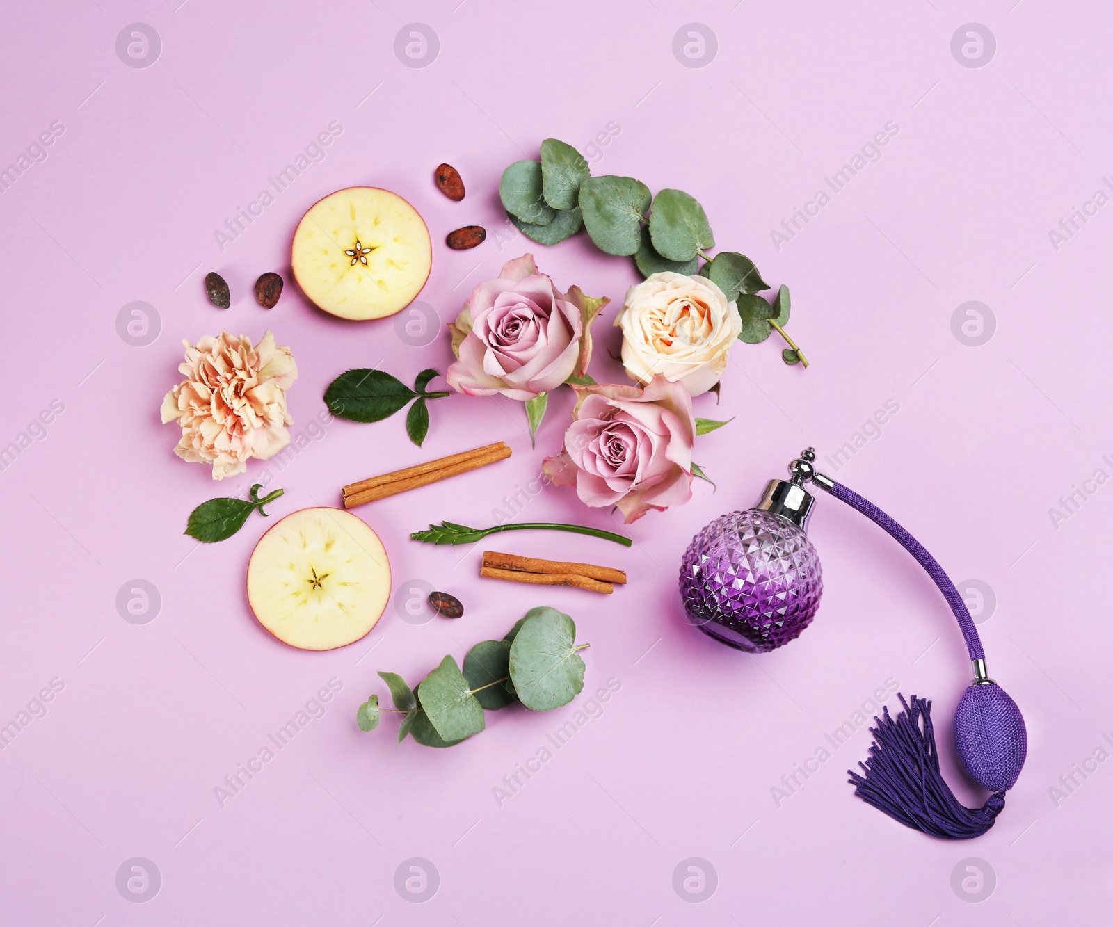 Beautiful flat lay composition with bottle of perfume, apple, cinnamon and flowers on lilac background Photo of Beautiful flat lay composition with bottle of perfume, apple, cinnamon and flowers on lilac background