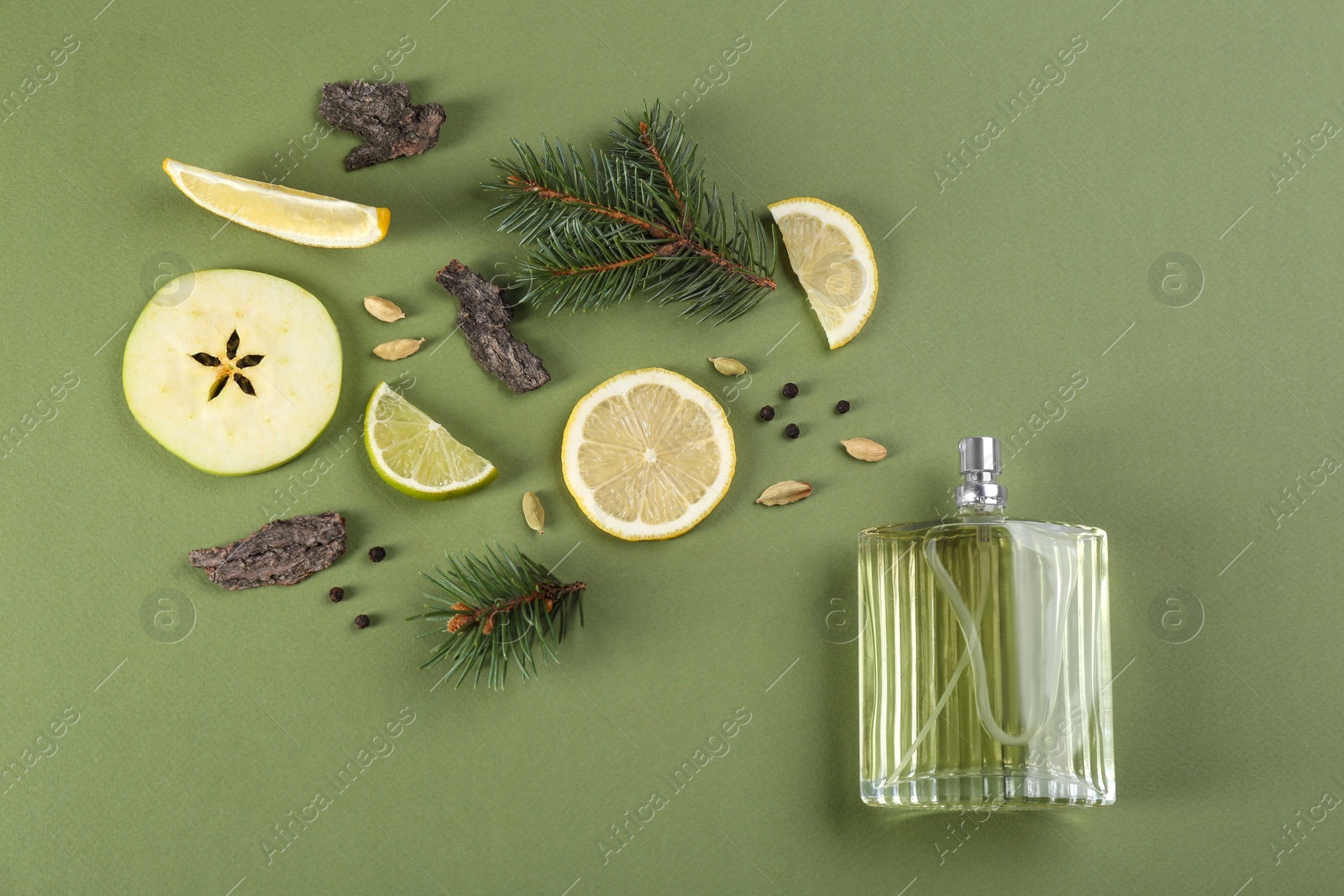 Flat lay composition with bottle of perfume on green background Photo of Flat lay composition with bottle of perfume on green background