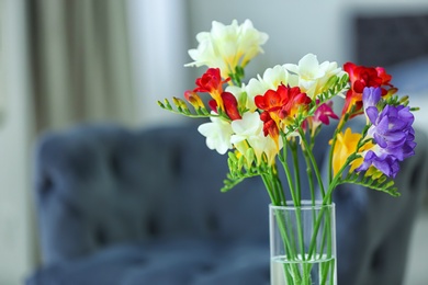 Beautiful bouquet with freesia flowers indoors Photo of Beautiful bouquet with freesia flowers indoors