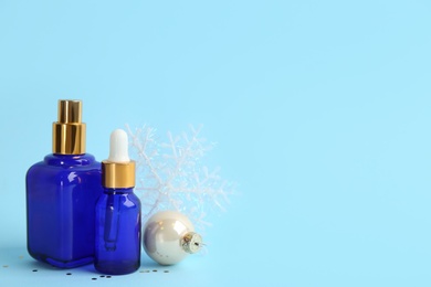 Beautiful composition with cosmetic products on light blue background, space for text. Winter care Photo of Beautiful composition with cosmetic products on light blue background, space for text. Winter care