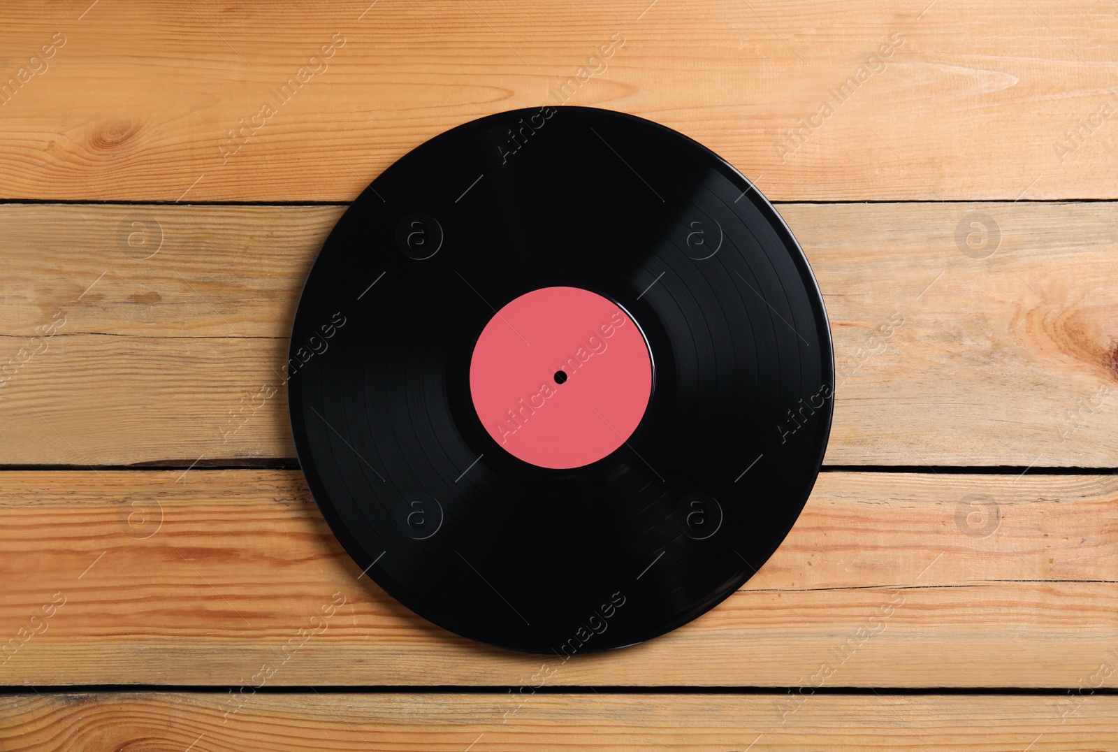 Vintage vinyl record on wooden background, top view Photo of Vintage vinyl record on wooden background, top view