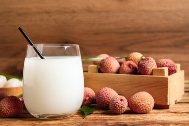 Lychee juice and fresh fruits on wooden table Photo of Lychee juice and fresh fruits on wooden table