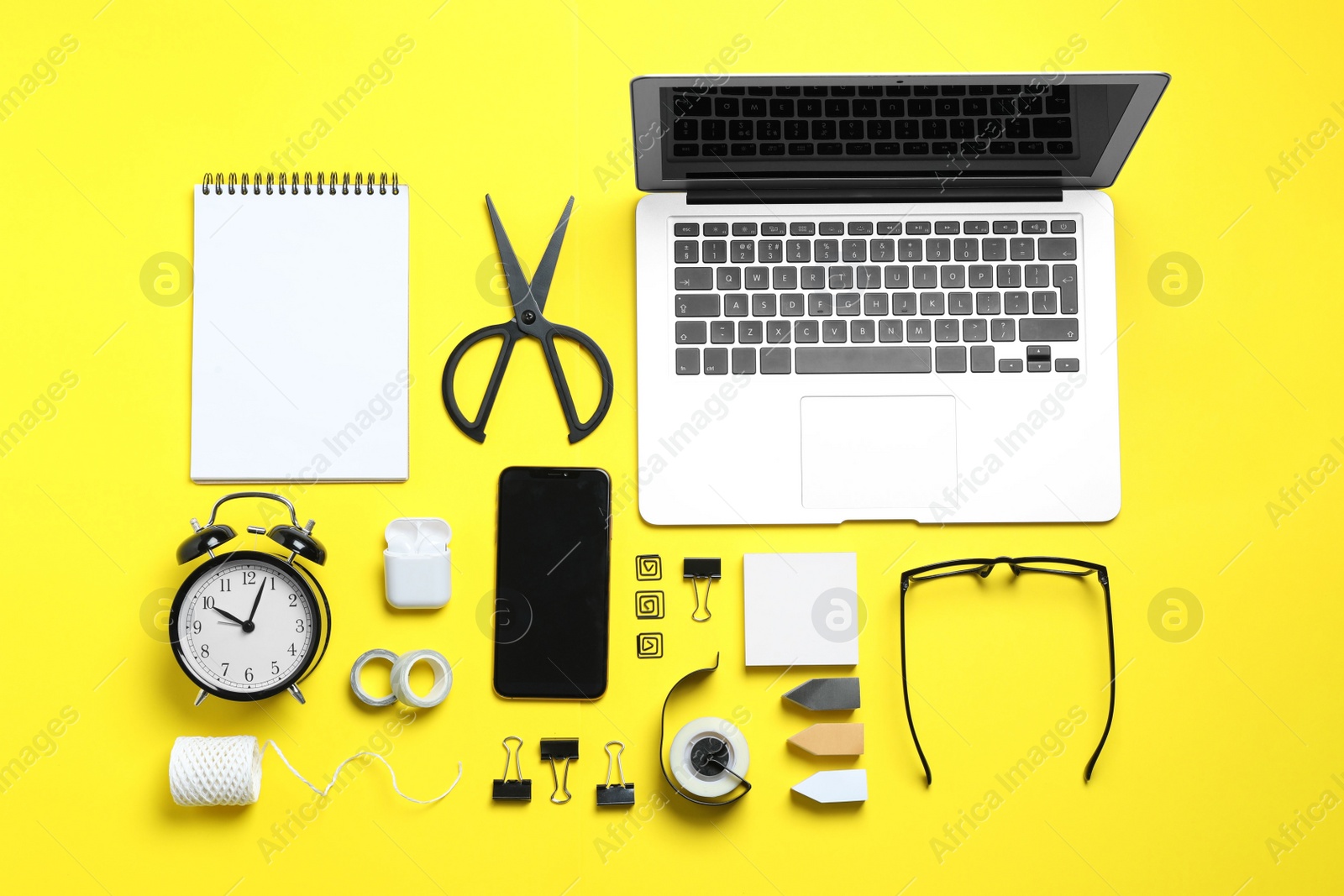 Flat lay composition with laptop, smartphone and stationery on yellow background. Designer's workplace Photo of Flat lay composition with laptop, smartphone and stationery on yellow background. Designer's workplace
