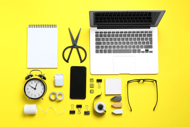 Flat lay composition with laptop, smartphone and stationery on yellow background. Designer's workplace Photo of Flat lay composition with laptop, smartphone and stationery on yellow background. Designer's workplace