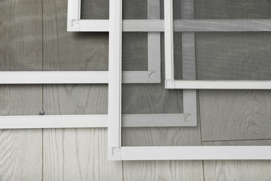 Photo of Set of window screens on wooden floor, closeup