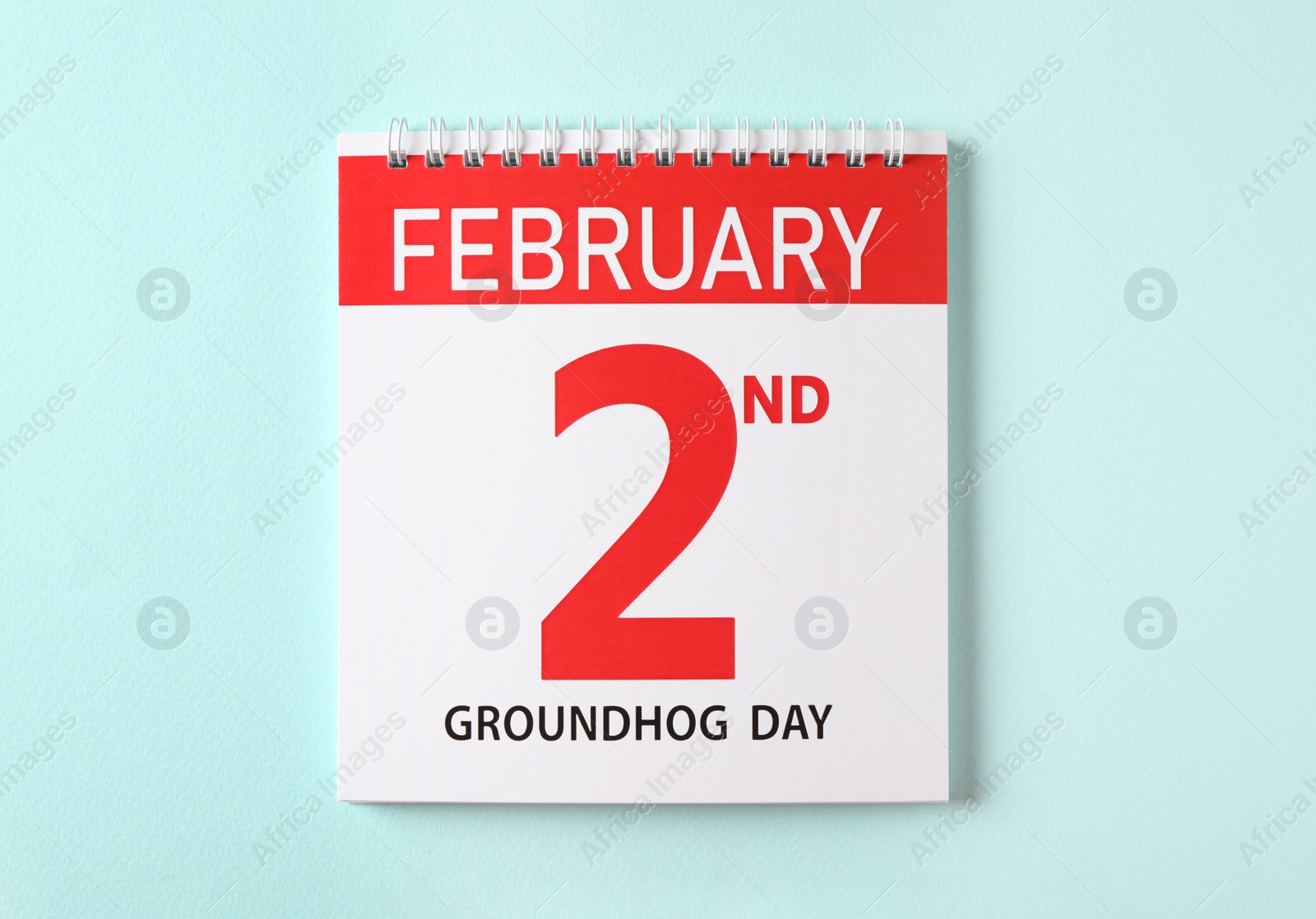 Top view of calendar with date February 2nd on light blue background. Groundhog day Photo of Top view of calendar with date February 2nd on light blue background. Groundhog day