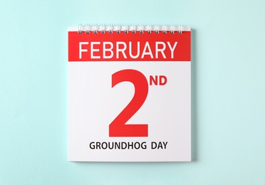 Top view of calendar with date February 2nd on light blue background. Groundhog day Photo of Top view of calendar with date February 2nd on light blue background. Groundhog day