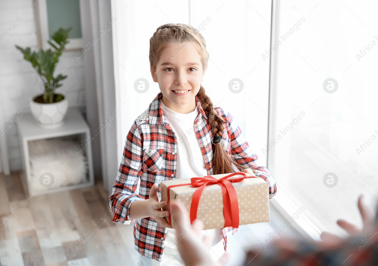Little girl giving her dad present for Father's Day at home Photo of Little girl giving her dad present for Father's Day at home