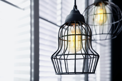 Stylish metallic pendant lamp with Edison light bulb indoors Image of Stylish metallic pendant lamp with Edison light bulb indoors