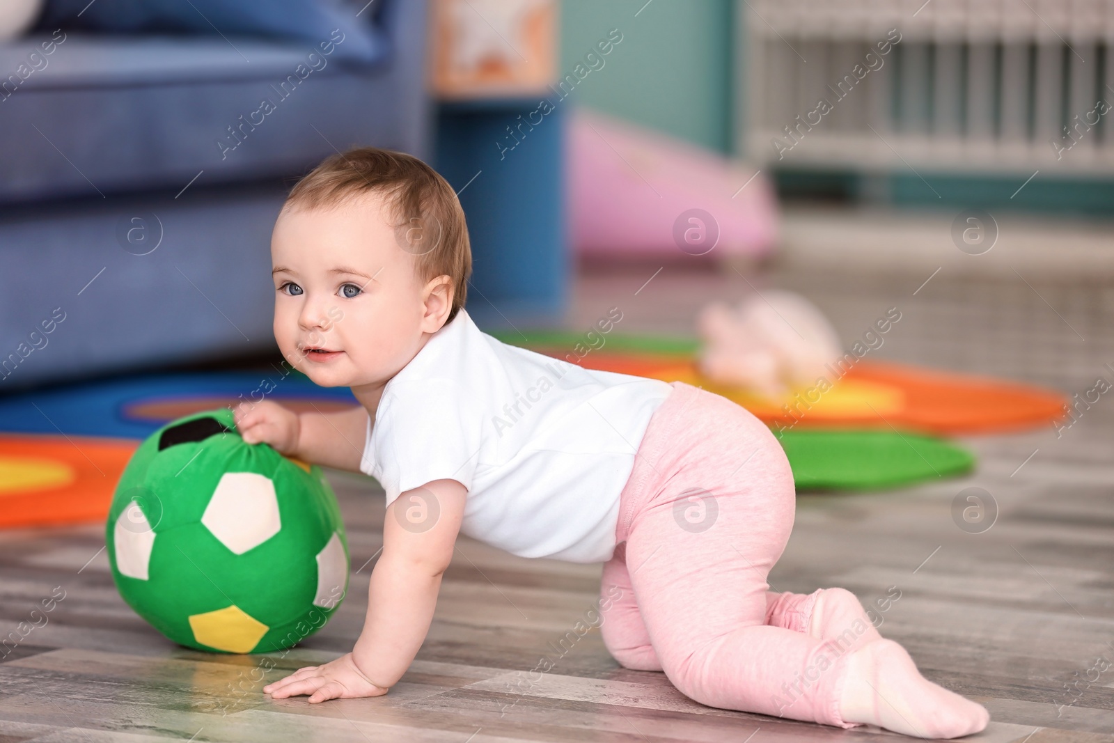 Cute baby playing with ball at home Photo of Cute baby playing with ball at home
