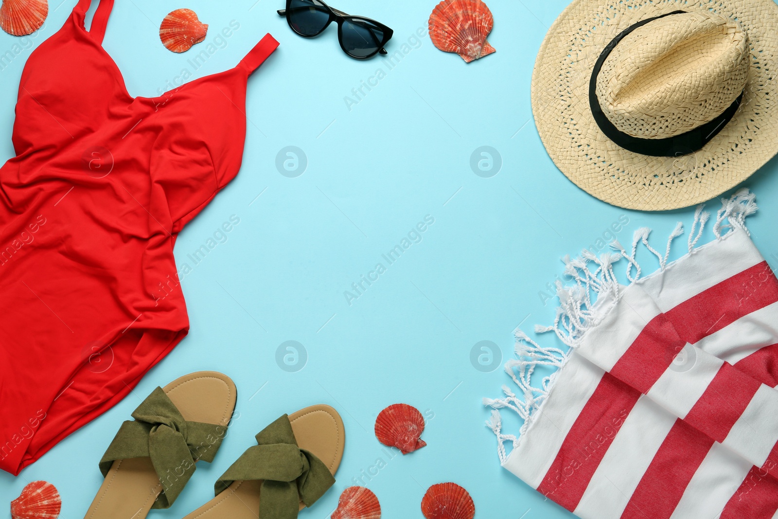 Frame made with different beach objects on light blue background, flat lay. Space for text Photo of Frame made with different beach objects on light blue background, flat lay. Space for text