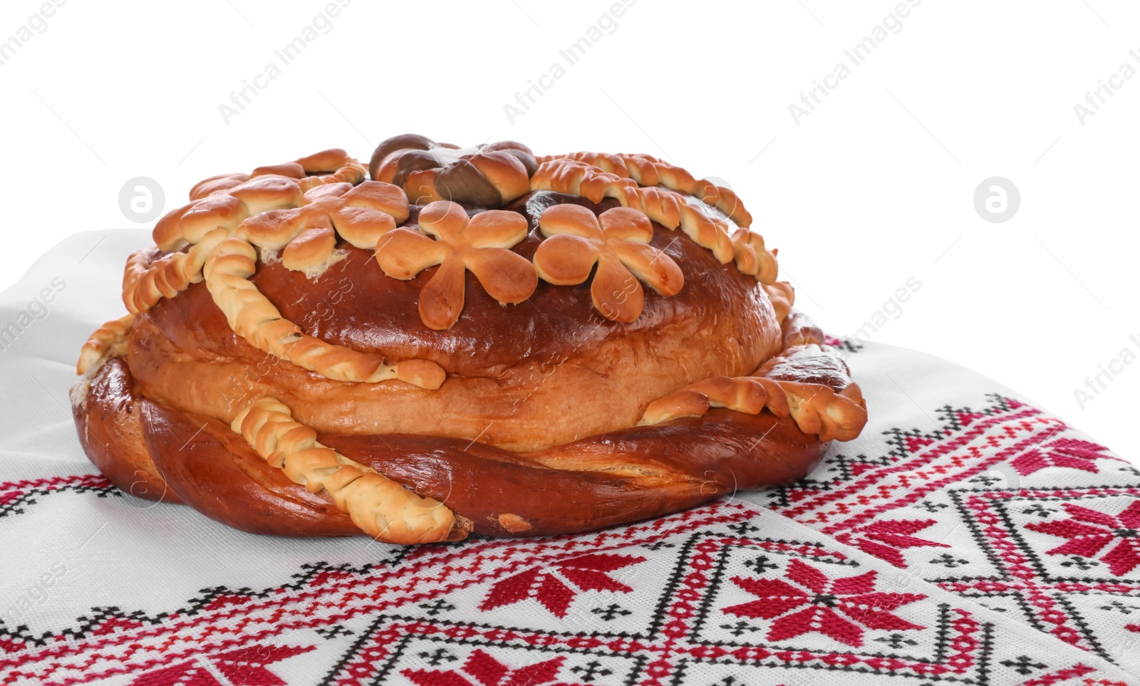 Rushnyk with korovai on white background. Ukrainian bread and salt welcoming tradition Photo of Rushnyk with korovai on white background. Ukrainian bread and salt welcoming tradition