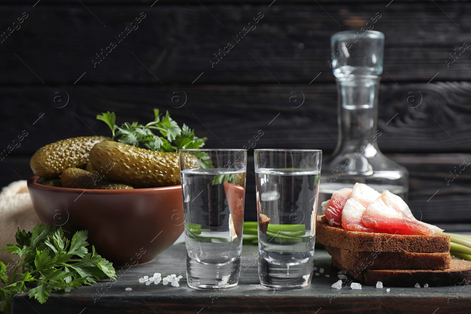 Cold Russian vodka with snacks on table Photo of Cold Russian vodka with snacks on table