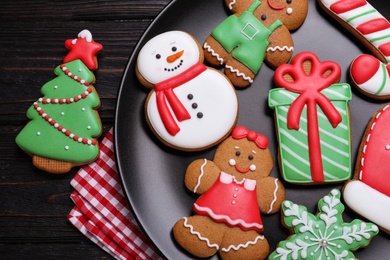 Delicious Christmas cookies on black wooden table table, flat lay Photo of Delicious Christmas cookies on black wooden table table, flat lay
