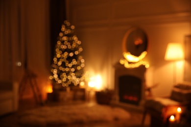 Blurred view of beautiful room interior with Christmas tree and fireplace Photo of Blurred view of beautiful room interior with Christmas tree and fireplace