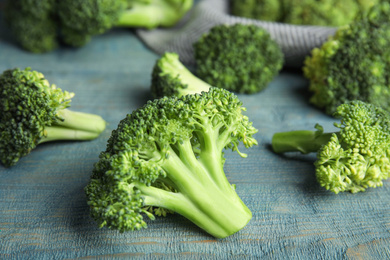 Fresh green broccoli on blue wooden table, closeup Photo of Fresh green broccoli on blue wooden table, closeup