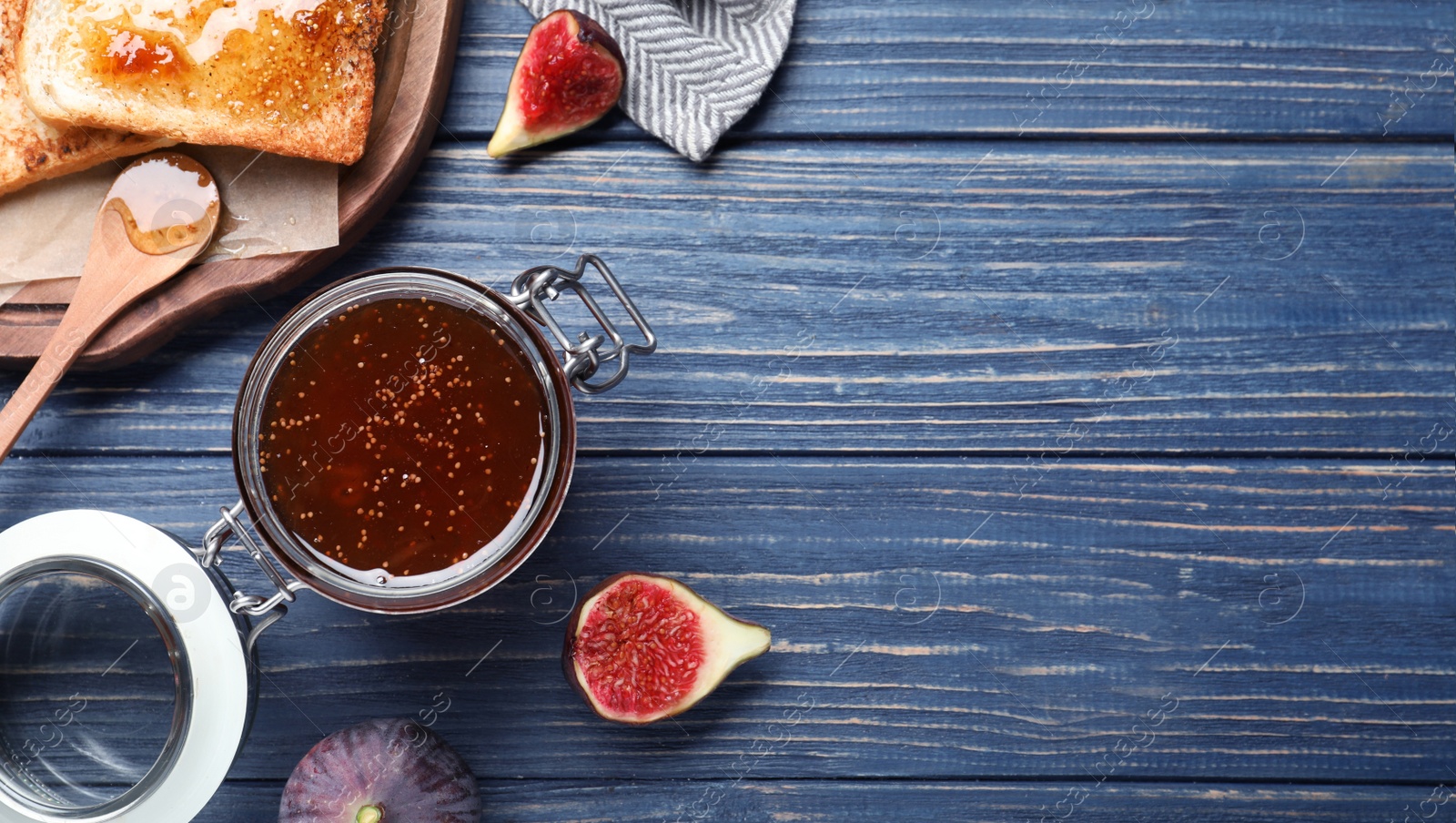 Flat lay composition with delicious fig jam on blue wooden table. Space for text Photo of Flat lay composition with delicious fig jam on blue wooden table. Space for text