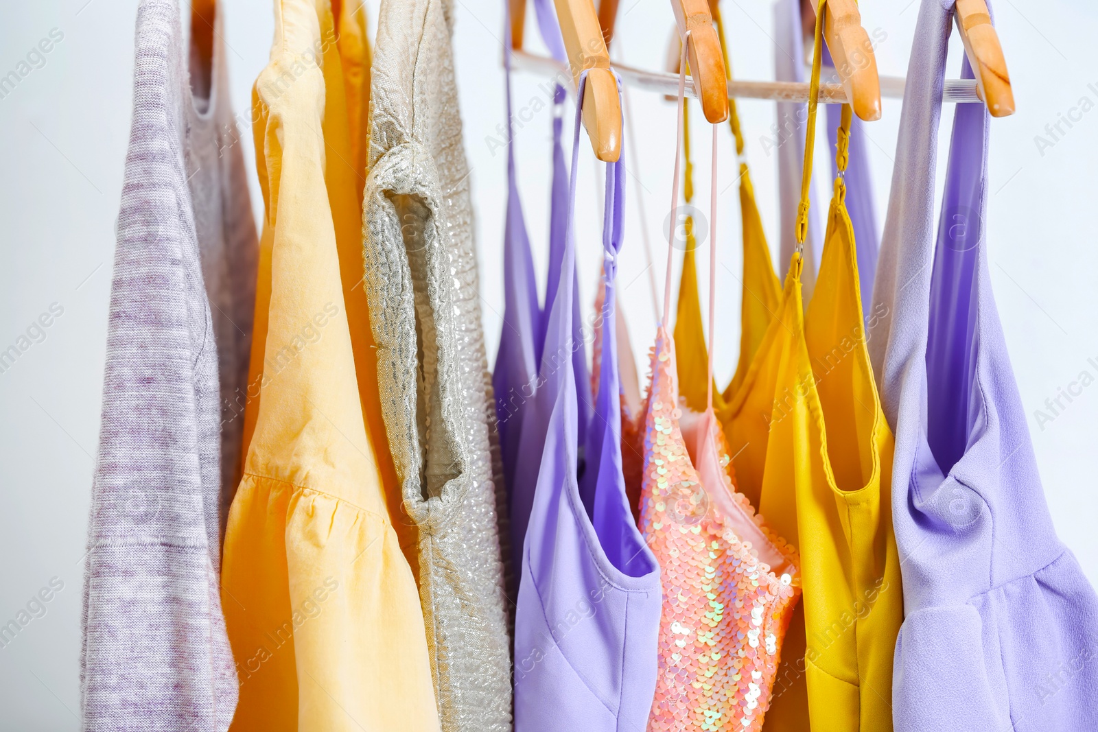 Different clothes on hangers, indoors Photo of Different clothes on hangers, indoors
